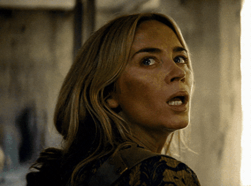 a close up of a woman with a surprised look on her face