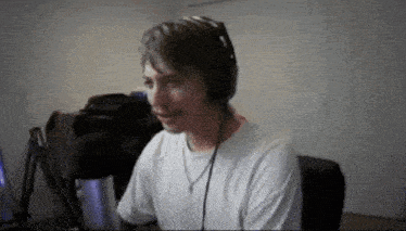 a man wearing headphones and a white shirt