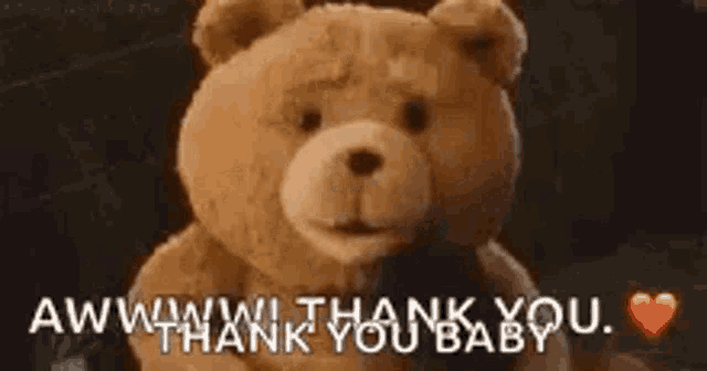 a teddy bear is holding a heart and saying `` aww , thank you baby '' .