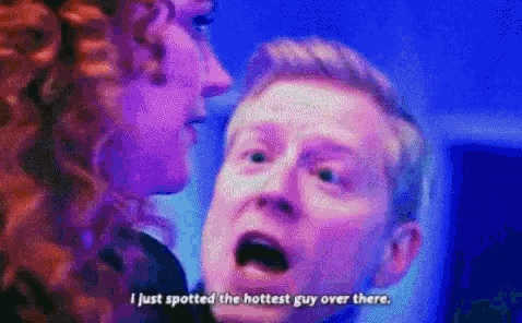 a man and a woman are talking to each other and the man is saying i just spotted the hottest guy over there .