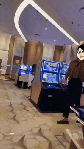 a man is standing in front of a slot machine that says joker on it