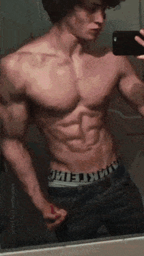 a shirtless man is taking a picture of himself in a mirror