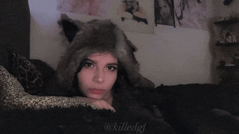 a girl wearing a wolf hat is laying on a leopard print blanket with the hashtag @killedgf