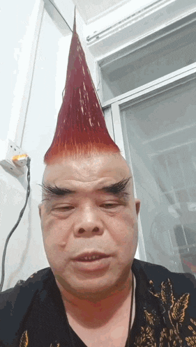 a man with a red mohawk on his head