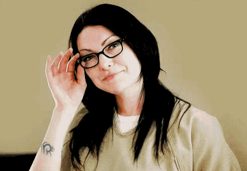 a woman wearing glasses and a tattoo on her wrist