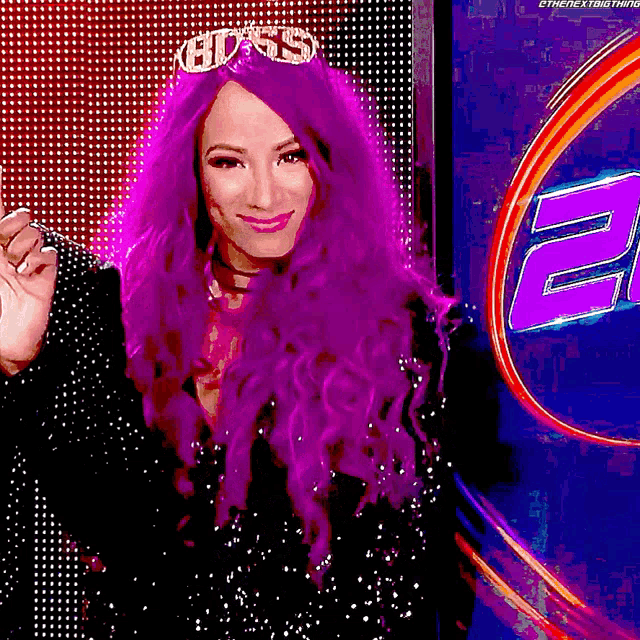 a woman with purple hair is wearing a tiara with the word boss on it