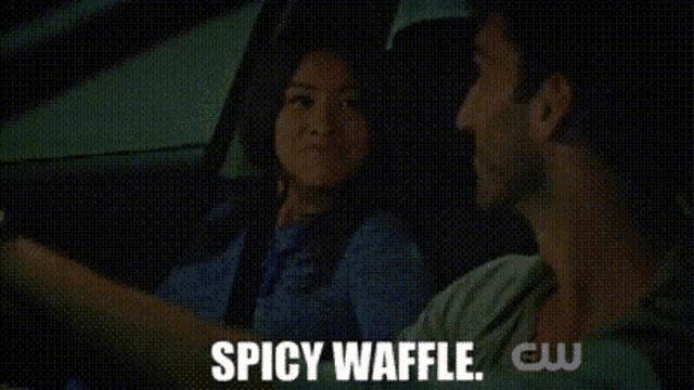 a man and a woman in a car with the words spicy waffle on the bottom right