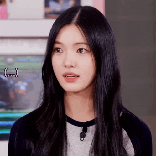 a woman with long black hair is looking at the camera with a smiley face behind her