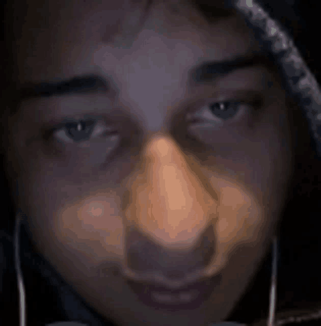 a close up of a person 's face with ear buds on