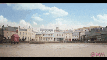 a row of buildings on a beach with the word mm on the bottom right