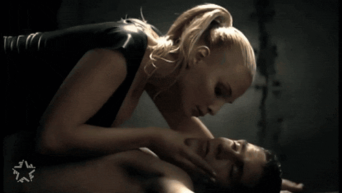 a woman is kissing a man on the neck with a star in the corner