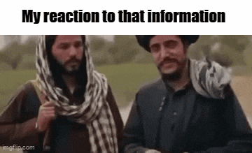 two men are standing next to each other in a field and one of them is wearing a scarf .