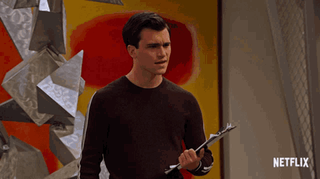 a man holds a clipboard in front of a netflix logo