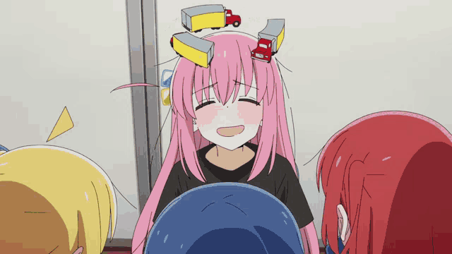 a girl with pink hair has a red truck on her head