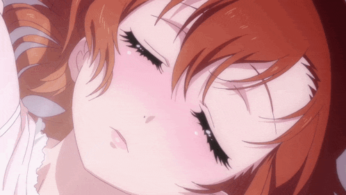 a close up of a girl with red hair sleeping