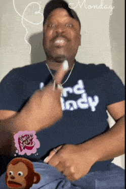 a man wearing a blue shirt that says monday