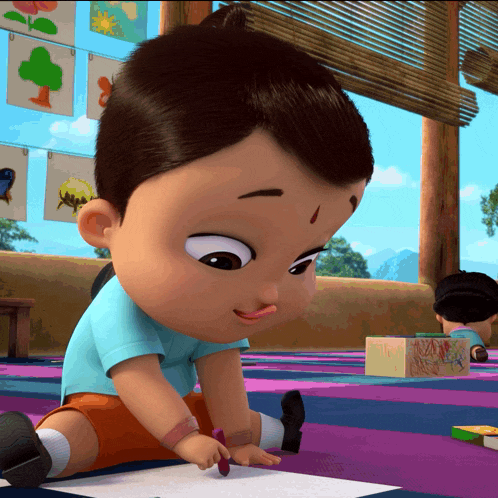 a baby is drawing on a piece of paper with a crayon