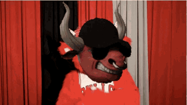 a bull wearing sunglasses and a hat with the letter t on the front