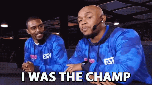 a man wearing a headset says " i was the champ " next to another man
