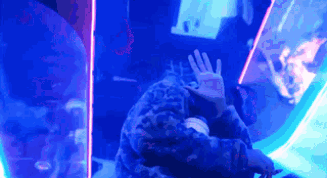 a person is playing a video game in a dark room