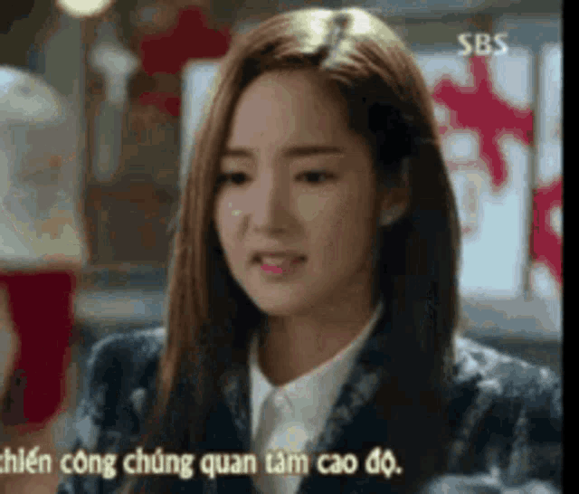 a close up of a woman 's face with the words sbs in the background