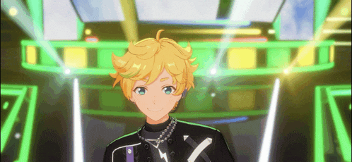 a boy with blonde hair and blue eyes is standing in front of a stage with green lights .