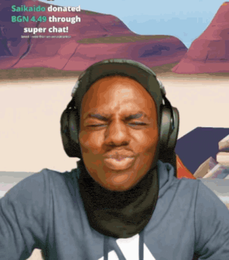 a man wearing headphones and a scarf with the words " saikaido donated bgn 4.49 through super chat "