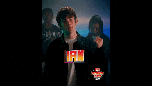 a young man is standing in front of a poster that says xxl