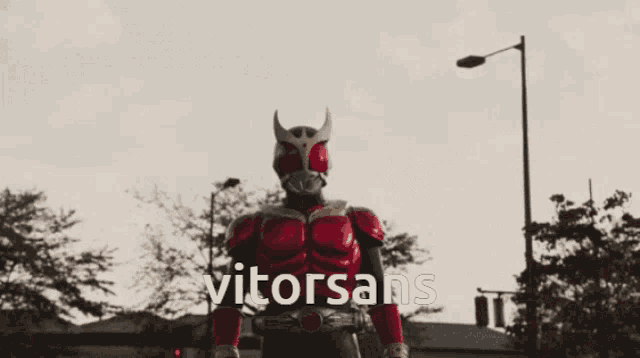 a man in a superhero costume is giving a thumbs up and the word vitorsans is on the bottom