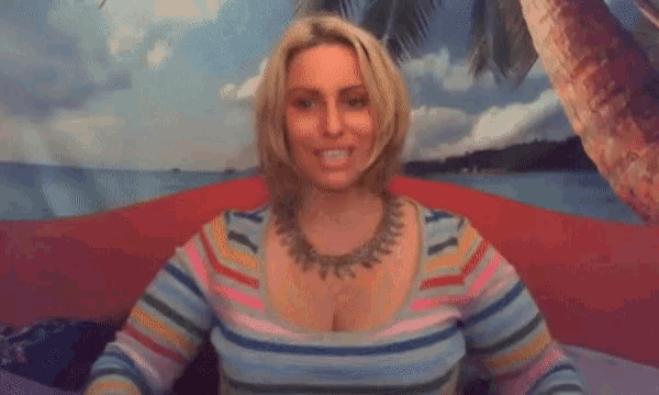 a woman in a striped sweater with her arms outstretched in front of a beach scene