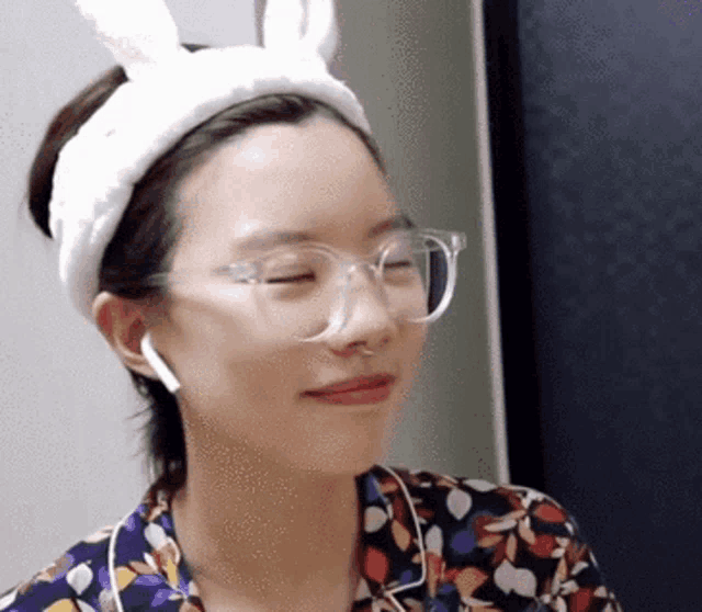 a woman wearing glasses and a headband with bunny ears