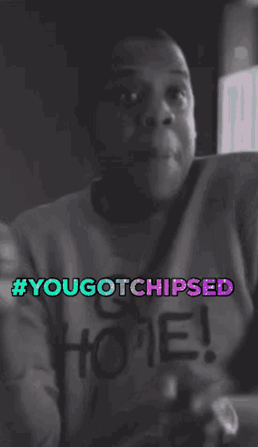 a black and white photo of a man wearing a shirt that says you got chipsed