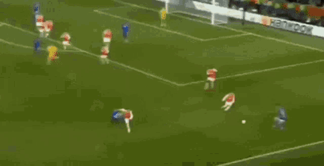 a group of soccer players are playing on a field with a hankook ad in the background