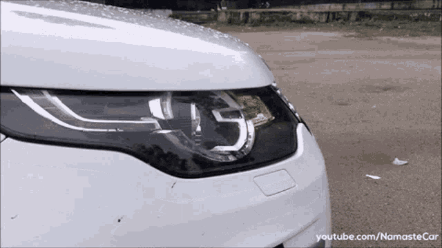 a close up of a car 's headlight with youtube.com/namastecar written on the bottom