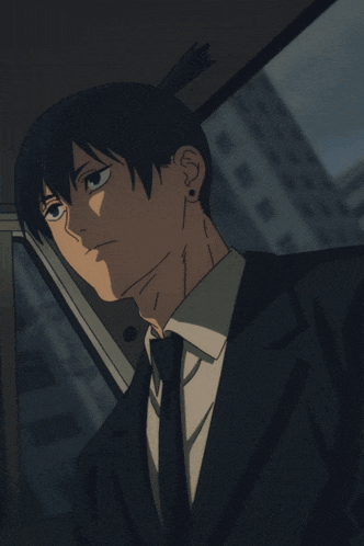 a man in a suit and tie talking on a phone