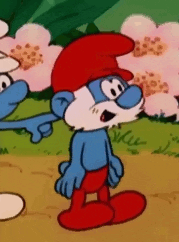 a cartoon smurf wearing a red hat and red pants is standing in a field .