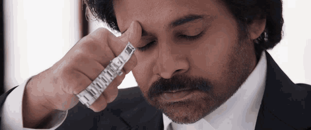 a man in a suit and tie is holding a ring that says ' montreal ' on it