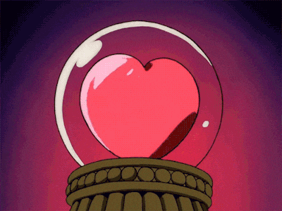 a glass ball with a heart inside of it on a pedestal