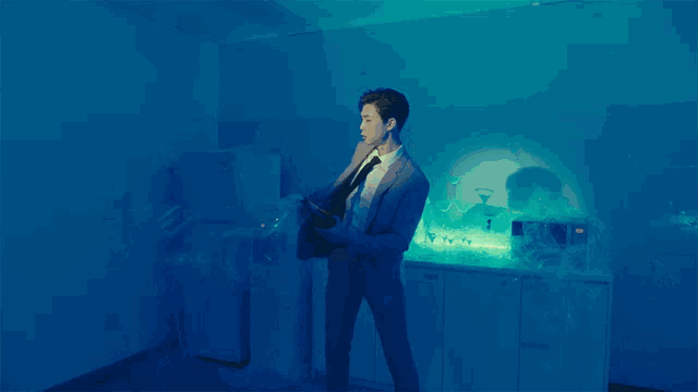 a man in a suit and tie holding a bottle of champagne