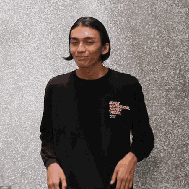 a man wearing a black shirt that says super beautiful secret weapon on it