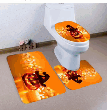 a toilet with a pumpkin on the seat and a pumpkin on the mat