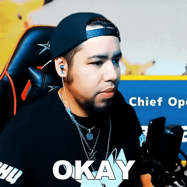a man wearing a hat and ear buds says okay