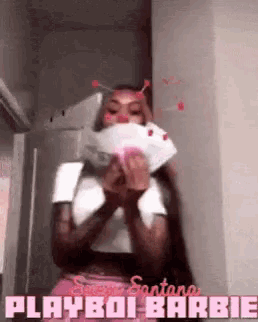 a woman is holding a bunch of money in her hands and says playboi barbie .