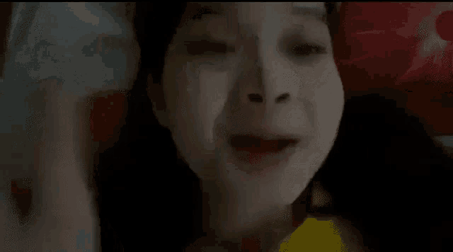 a close up of a woman 's face laying on a bed .
