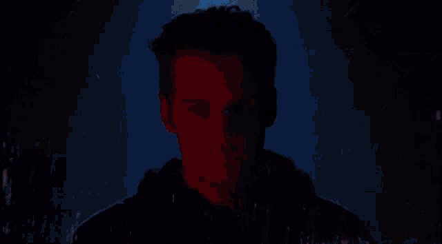 a silhouette of a man 's head is against a blue background