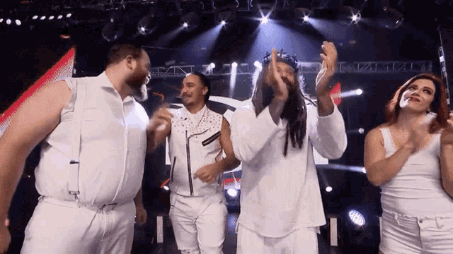 a group of people are dancing in front of a stage with a sign that says ' a ' on it