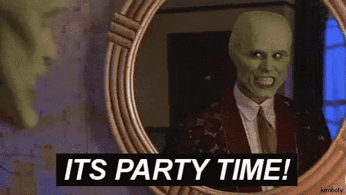 a man with a mask is looking at himself in a mirror and says it 's party time .