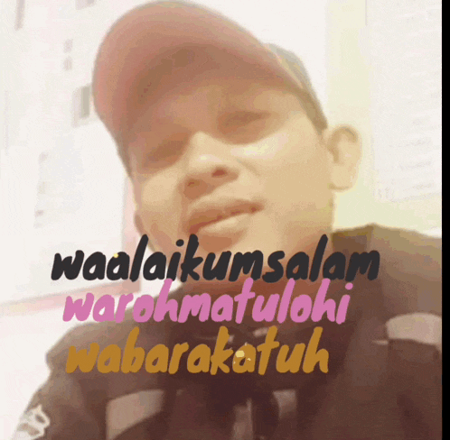 a man wearing a red hat with the words waalaikumsalam written on it
