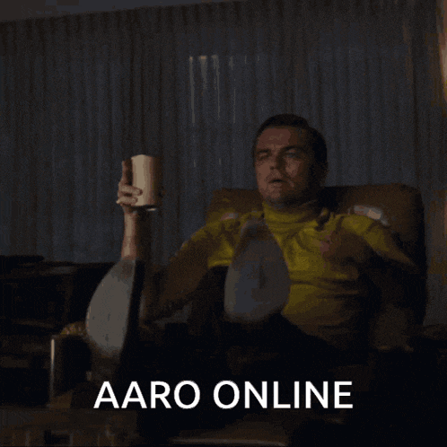 a man sitting in a chair with a cup in his hand and the words aaro online written below him