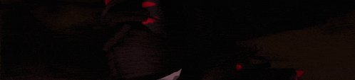 a close up of a person 's face in the dark